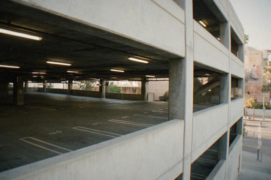 Parking structure entrance on a busy Los Angeles boulevard near museum buildings