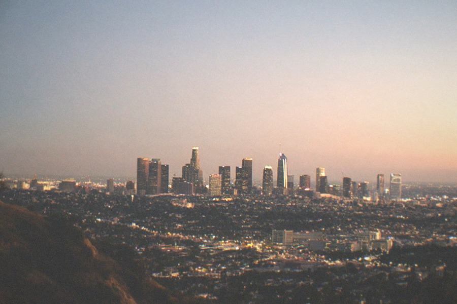 The Los Angeles skyline at dusk seen from a hillside overlook near the observatory