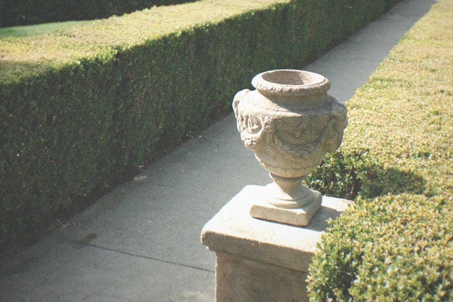 Garden terrace with sculpted hedges, a maze-like layout and city haze beyond