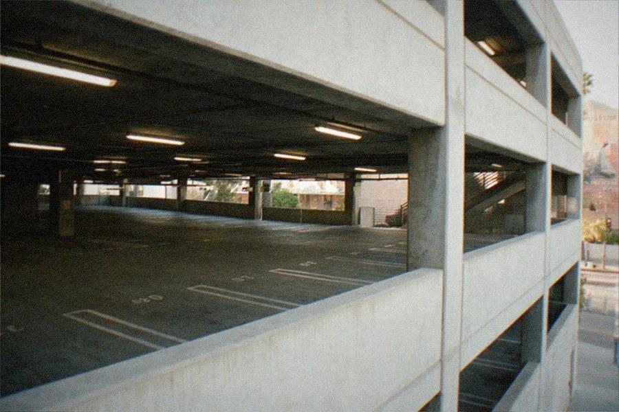 Museum parking structure entrance with cars and signage